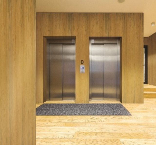 Teak wood veneer wall panels in a luxury hotel lobby by Mikasa Decowood Veneers